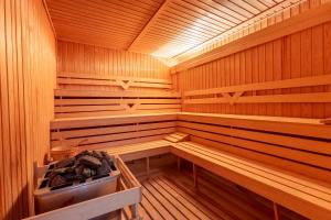 an empty sauna with wooden walls and wooden shelves at Hotel Sea Sand in Sveti Vlas