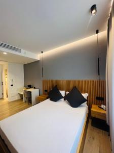 a bedroom with a large white bed with two pillows at La Chambre Milano in Milan