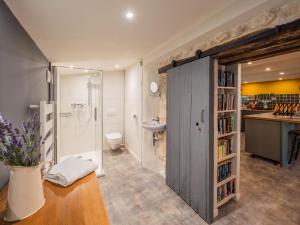 a bathroom with a shower and a toilet and a sink at Carmagnac Cowshed in Vaux-Lavalette +145 photos