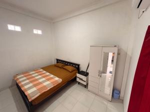 Postel nebo postele na pokoji v ubytování Dewananda Homestay