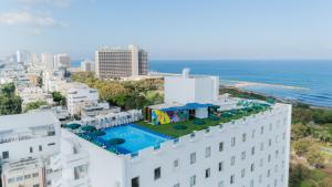 an aerial view of a building with a swimming pool at Grand Beach Hotel in Tel Aviv
