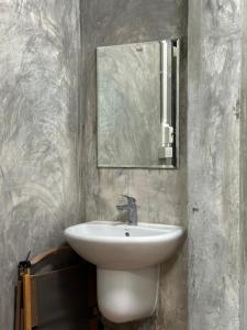 a bathroom with a sink and a mirror at DHome and Gardens in Phibun Mangsahan +24 photos