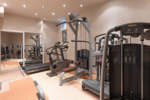 a gym with several tread machines in a room at Hotel Sea Sand in Sveti Vlas