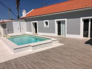 a swimming pool in the backyard of a house at Casas Morgado in Valada