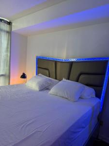 a bedroom with a bed with blue lights on it at CN Tower & Lake views, 1 bedroom plus den in Toronto