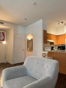 a living room with a couch and a kitchen at CN Tower & Lake views, 1 bedroom plus den in Toronto
