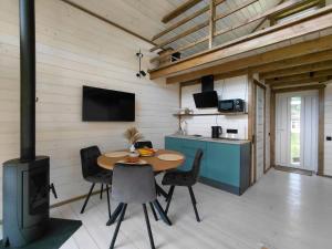 a kitchen and dining room with a table and a stove at KBarn in Krasnik