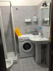 a bathroom with a washing machine and a sink at Case Cincotta- Agliozzo in Lipari +24 photos