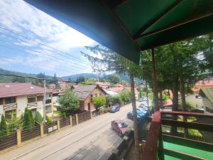 a view of a city street from a balcony at Casa cu Brazi in Buşteni