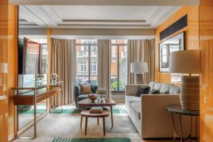 a living room with a couch and a table at Four Seasons Hotel London at Park Lane in London