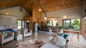 a large living room with a table and chairs at Never Never Cabin in Gleniffer