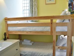 two bunk beds in a bathroom with a sink at Howegrain Lodge in Glenridding