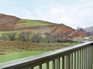 a view of a hill from a bridge at Howegrain Lodge in Glenridding +2 photos