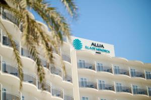 a large white hotel with a sign on it at Alua Illa de Menorca in S'Algar