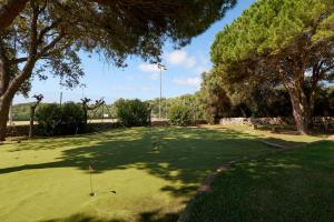 a golf course with a hole in the grass at Alua Illa de Menorca in S'Algar