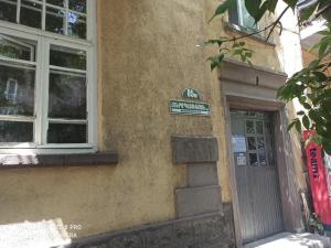 a sign on the side of a building with a door at Guest House Armen in Yerevan