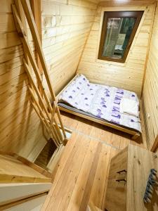an overhead view of a bed in a wooden cabin at Vikendica MIČIĆ in Šašiceva Ada