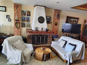 a living room with a couch and a fireplace at Marilyn's house in Amarynthos