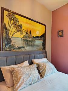 a painting above a bed in a bedroom at Marilyn's house in Amarynthos