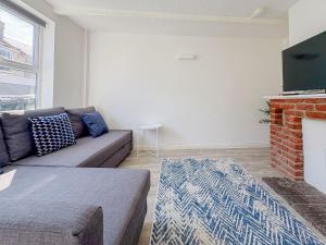 a living room with a couch and a fireplace at York Road in Great Yarmouth
