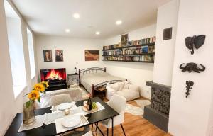 a living room with a table and a fireplace at Atlas Apartments in Komárno