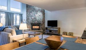 a living room with a couch and a fireplace at Convenient 2Br Condo Near Lionshead Village With Resort Amenities in Vail