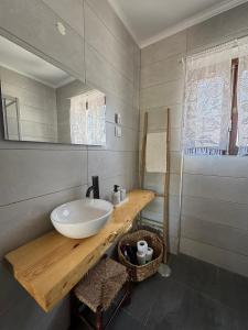 a bathroom with a white sink and a mirror at Casa das Laranjeiras in Alfarim +35 photos