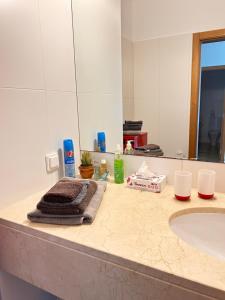 a bathroom counter with a sink and a mirror at Vista Dourada in Porto Santo +17 photos