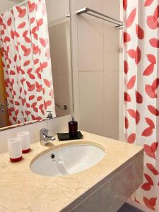 a bathroom with a sink and a mirror at Vista Dourada in Porto Santo