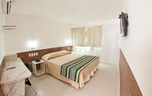 Postel nebo postele na pokoji v ubytování Hotel Corais de Tambau