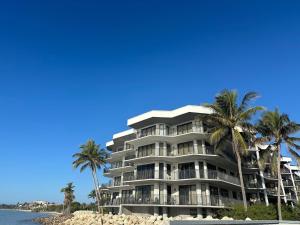 a large building on the beach with palm trees at Nautical Adventures in Paradise in Key West
