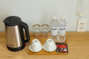 a counter with a coffee maker and bottles of water at Diamond crown 2 Hotel in Ho Chi Minh City