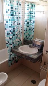 a bathroom with a sink and a shower curtain at Aloha 1º linea playa Benalmadena in Benalmádena