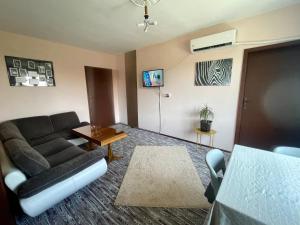 a living room with a couch and a table at Къща за гости САРАЯ Ретро стил in Svishtov