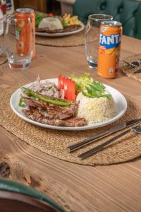 a plate of food with rice and meat and vegetables at Oria Hotel Boutique in Çamlıhemşin