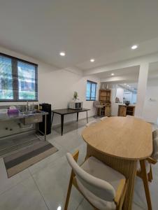 a living room with a table and a dining room at Luxury Tropical Bungalow in Damansara Golden Core in Kuala Lumpur