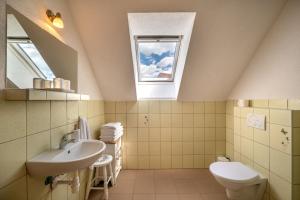 a bathroom with a sink and a toilet and a window at River Cottage Bešeňová in Bešeňová +67 photos