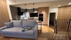 a living room with a couch and a kitchen at Casa Lucia in Valdidentro