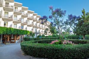 a building with bushes and flowers in front of it at The Grove Seaside Hotel in Dhrepanon