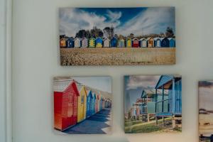 a group of four pictures of colorful beach huts at Hello Zeeland - Vakantiewoning PJ Eloutstraat 13 in Domburg