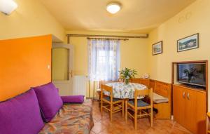 a living room with a purple couch and a table at Villa Draga by Villas Guide in Mošćenička Draga