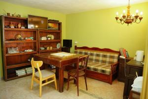 a room with a desk and a couch and a table at Lemon House in Tirana