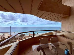a balcony with a view of the beach and the ocean at Royal King David Apartment in Netanya