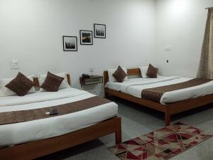 Postel nebo postele na pokoji v ubytování Hotel O Mysore Zoological Park Formerly Queens Comfort