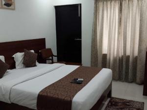 Postel nebo postele na pokoji v ubytování Hotel O Mysore Zoological Park Formerly Queens Comfort