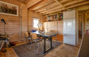 a kitchen with a table and a refrigerator at 1 Bedroom Stunning Home In Menaam in Dronrijp