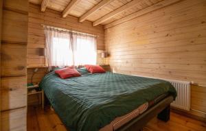 a bedroom with a bed in a wooden room at 1 Bedroom Stunning Home In Menaam in Dronrijp