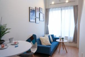 a living room with a blue couch and a table at つるのや鶴見105 in Yokohama
