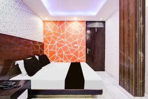 a bedroom with a bed and a wooden wall at Hotel O Priya Palace in New Delhi