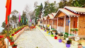 a row of cottages with plants inront of them at The Local Treat in Pedong